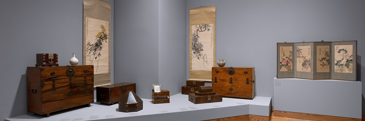 a collection of korean furniture and wall hangings on display at WAM