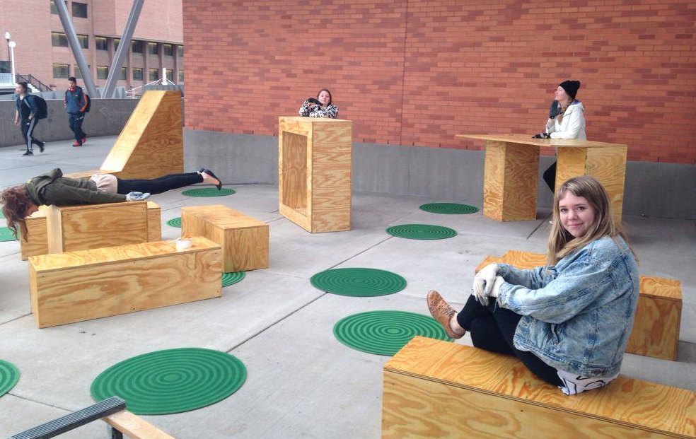 People hanging out on plywood boxes