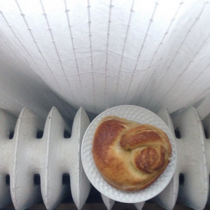 A croissant on a plate on a radiator