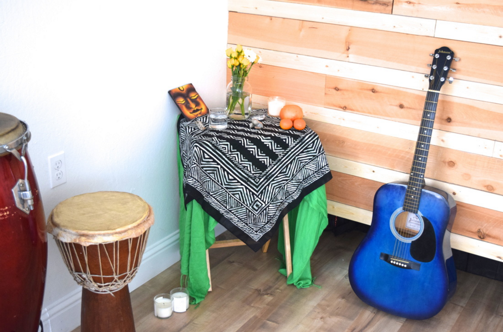 A drum, a table, and a blue guitar