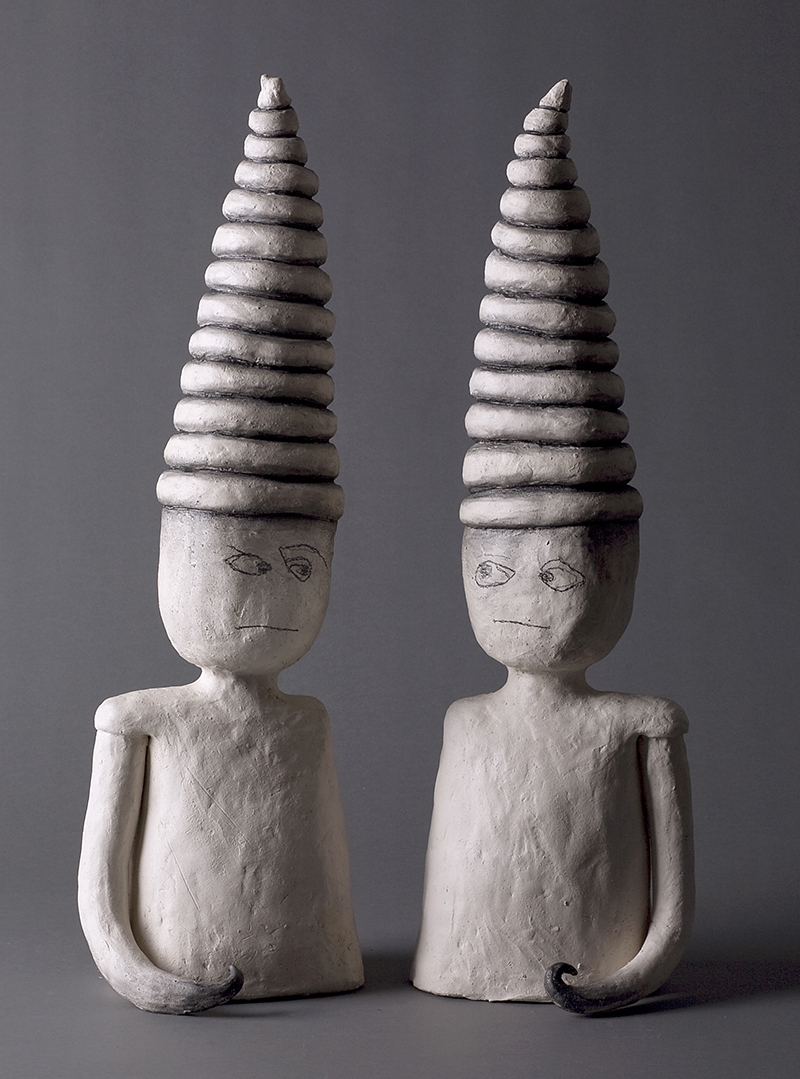 two scultpures with tall hats