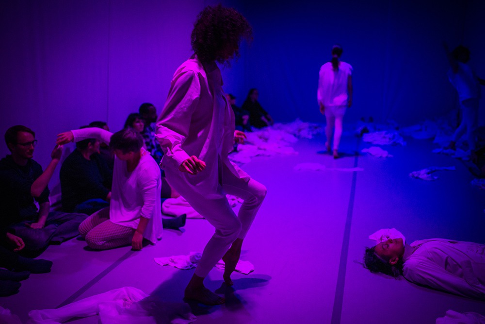 dancers in a blue and purple art space