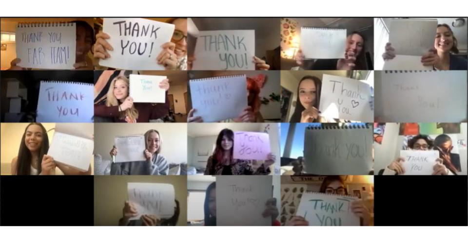 Zoom screen of people holding up "thank you" signs