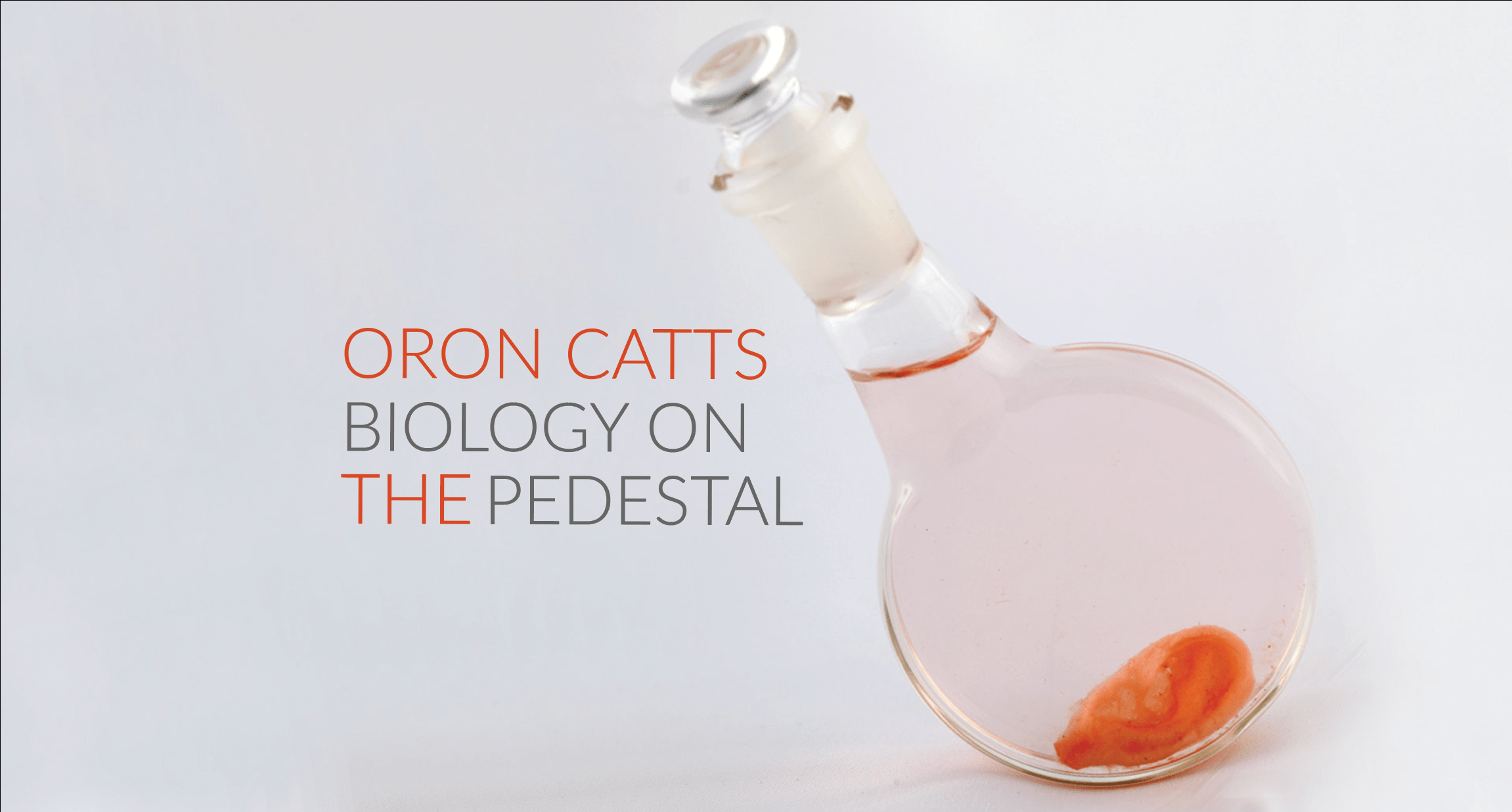 beaker wirh specimin in it next to text "Oron Catts Biology on the Pedestal"