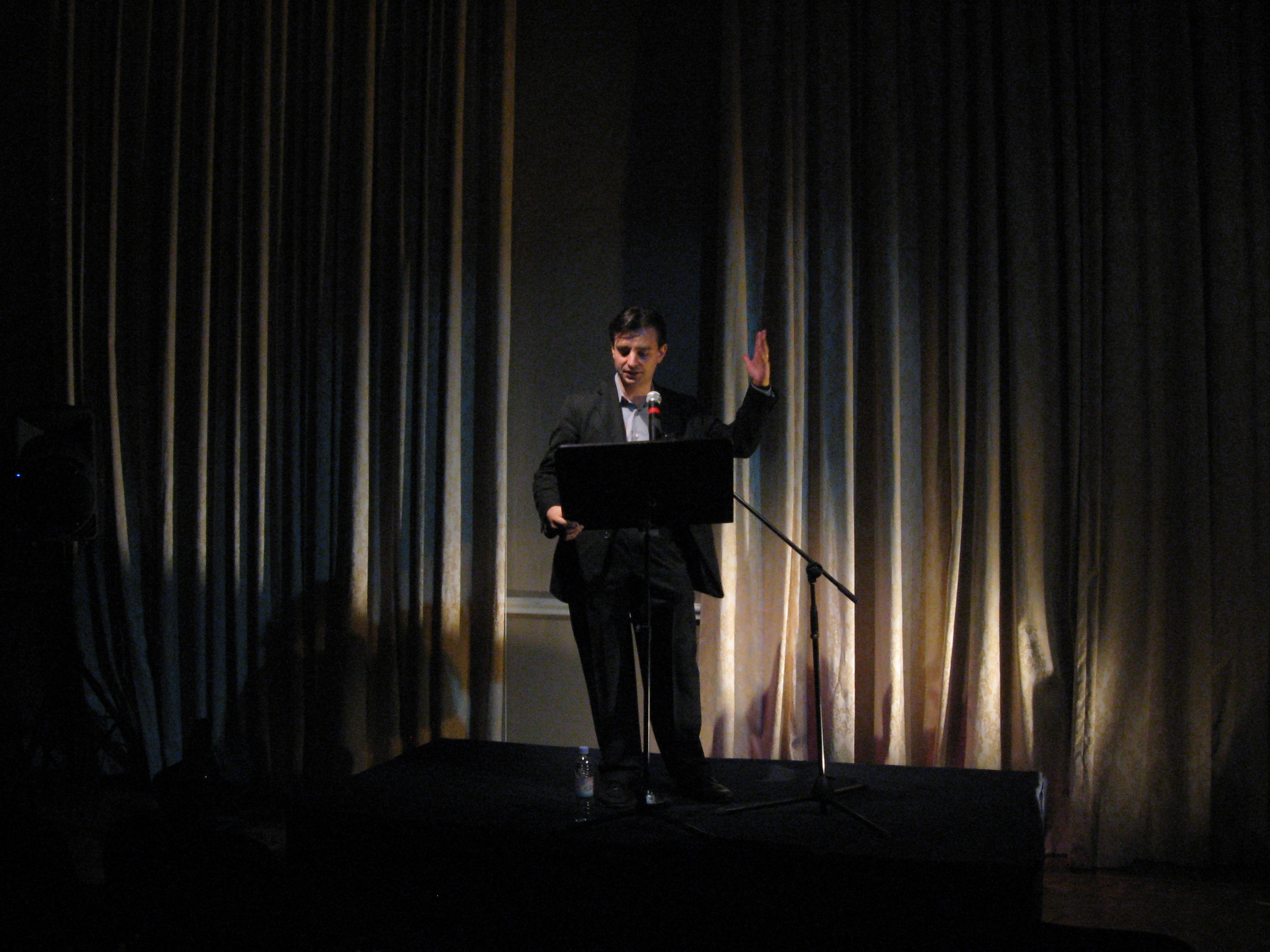 Pablo Helguera speaking onstage 