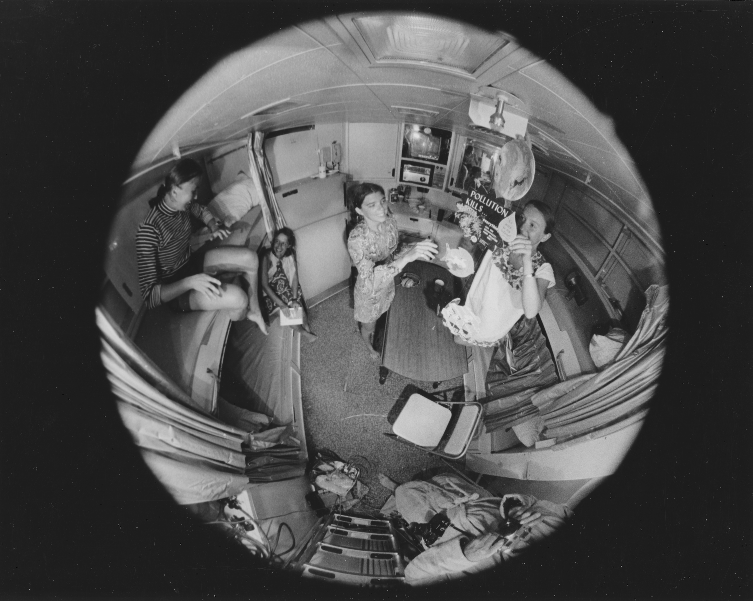 people in an apartment through a fisheye lens