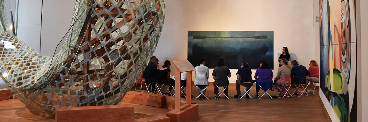 group of people listening to tour guide surrounded by art