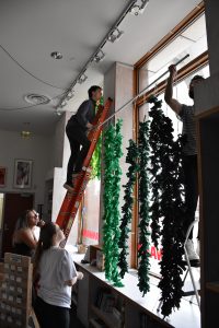 People decorating a window
