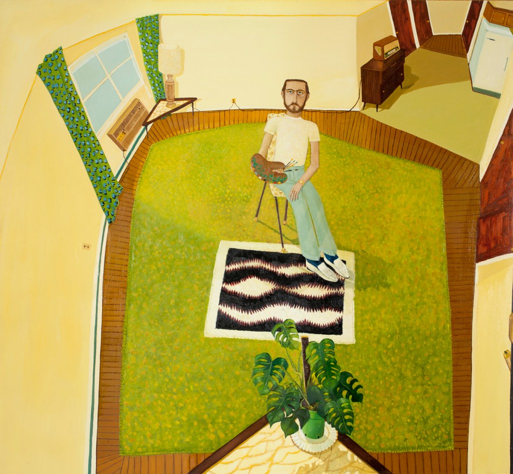 person sitting on chair on green rug in small room
