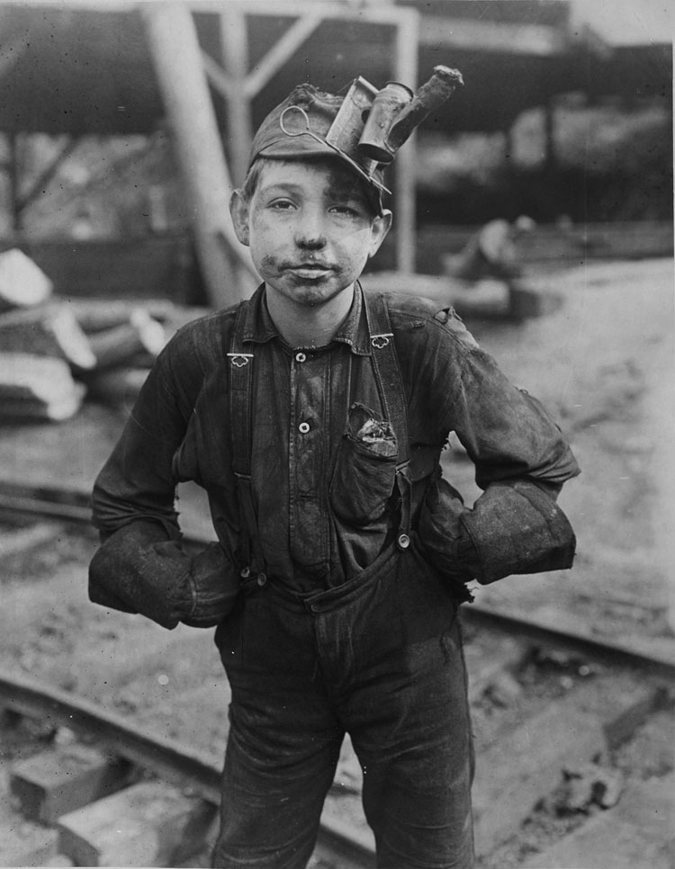 a young boy coal miner photographed in black and white