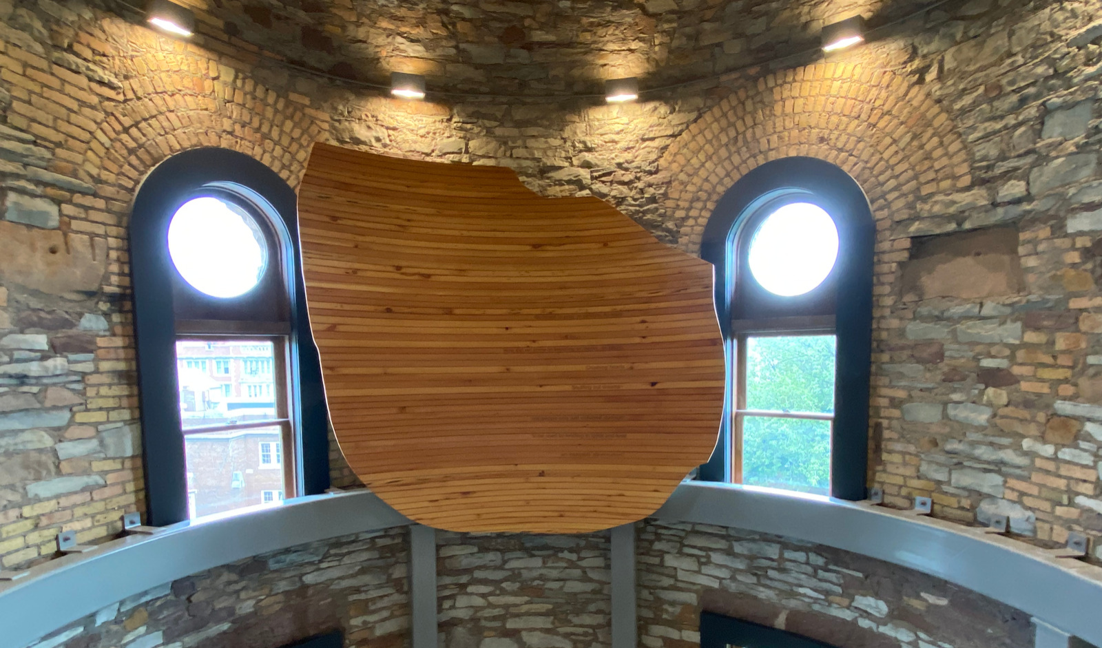 wooden art installation in a round stone room