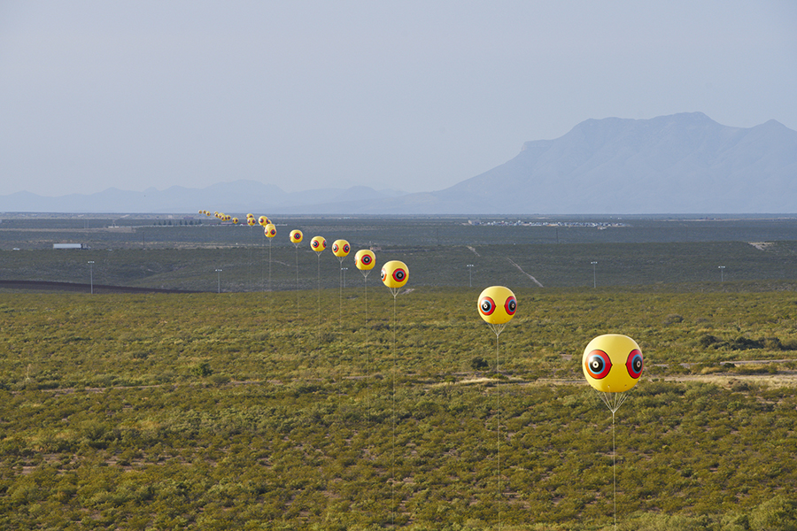 A line of yellow balloons with bullseyes on them