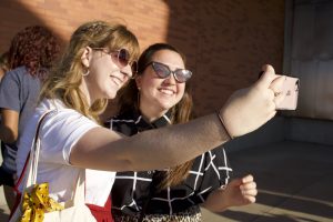 2 people in sunglasses taking a selfie