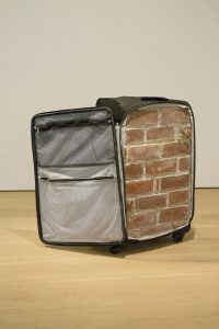 Luggage with a brick wall inside