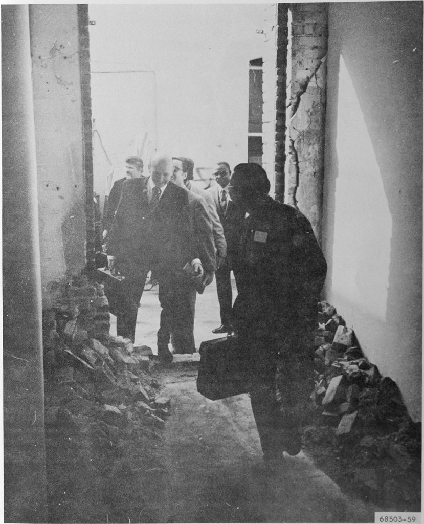 An old black and white photo of people in a hallway