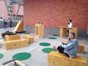 People sitting on plywood boxes