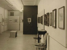 a line of paintings on the wall
