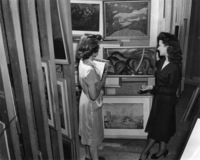 2 people looking at artwork