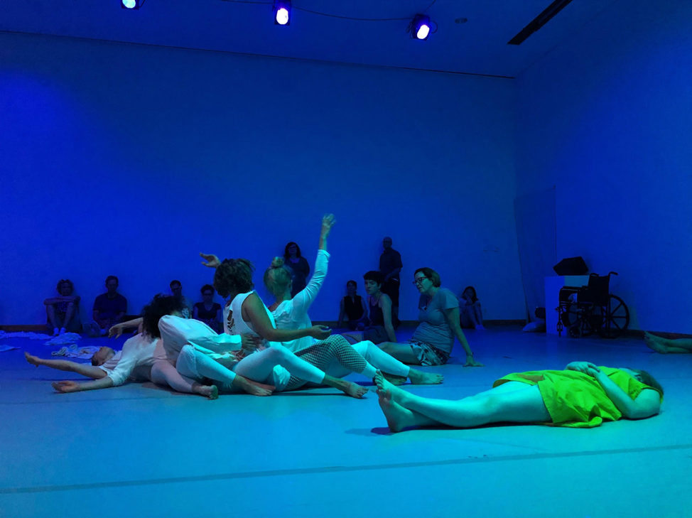 Several people lying on the floor in a blue room