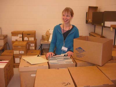 A person surrounded by cardboard boxes