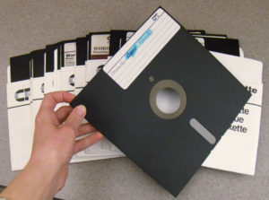 hand holding an old floppy disk