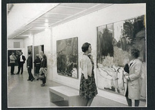 People in a hall looking at artwork