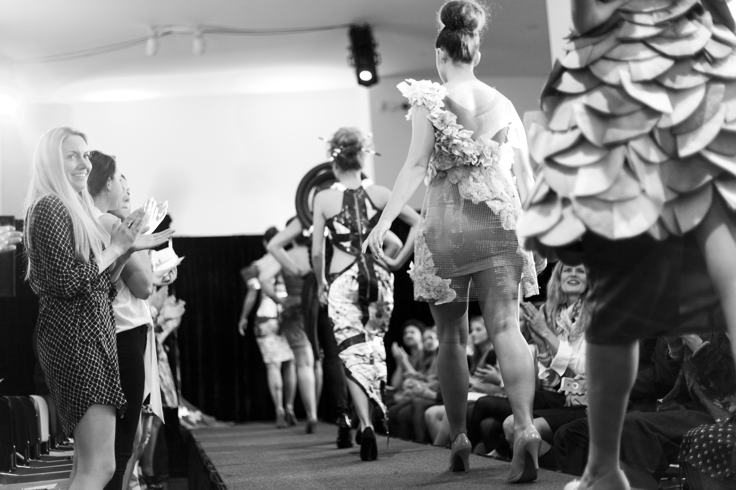 A row of people walking down the runway