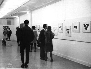people looking at artwork on the wall