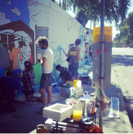 A group of people working on a mural