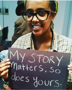 a person holding a sign saying 'my story matters, so does  yours'