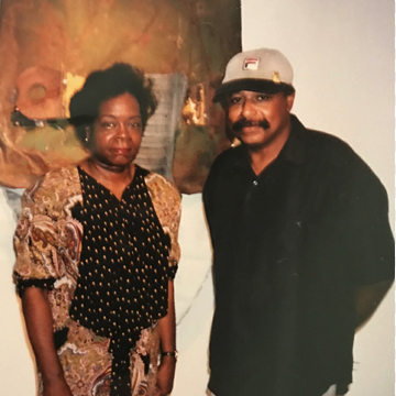 Rose and Melvin Smith standing in front of artpiece