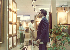 A man looking at a wall of plaques