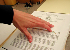 A hand resting on a paper