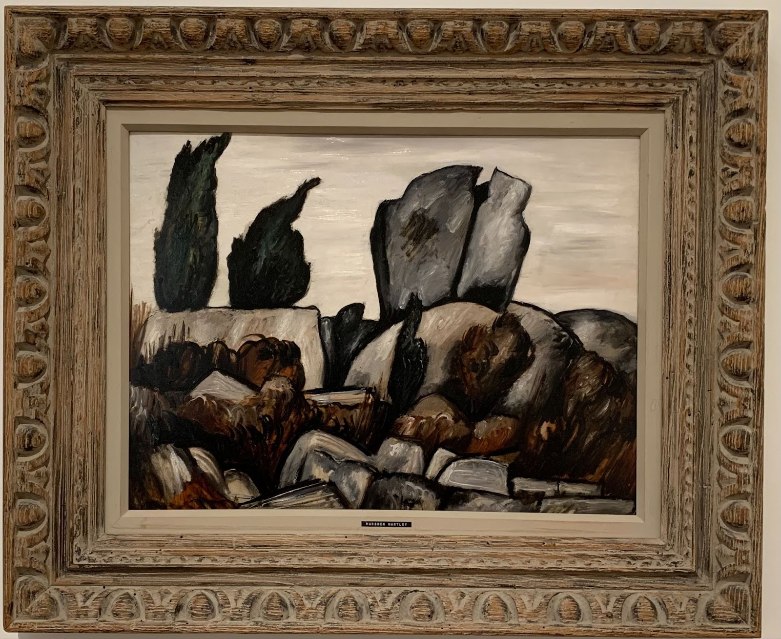 oil painting of rocks and trees against stormy sky