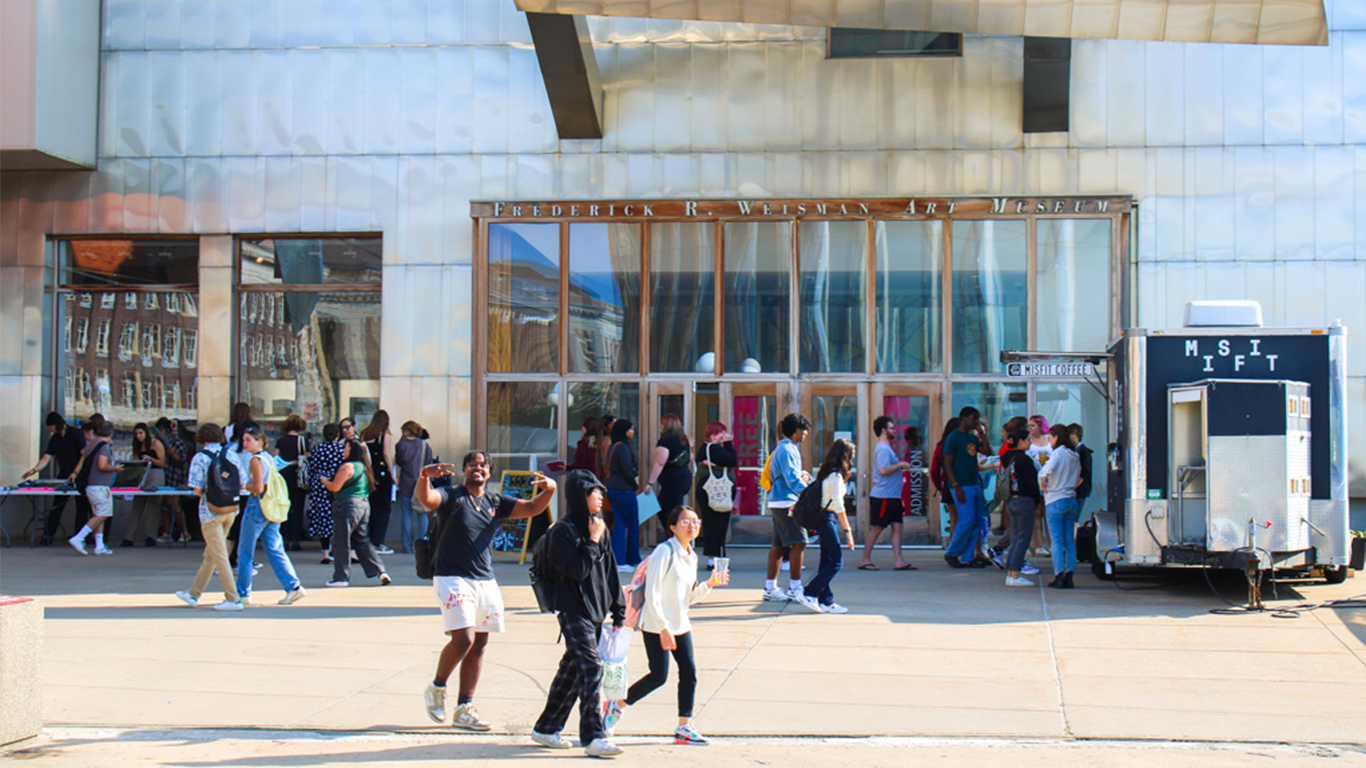 Students throng at the entrance of the Weisman during Welcome Week events in 2023