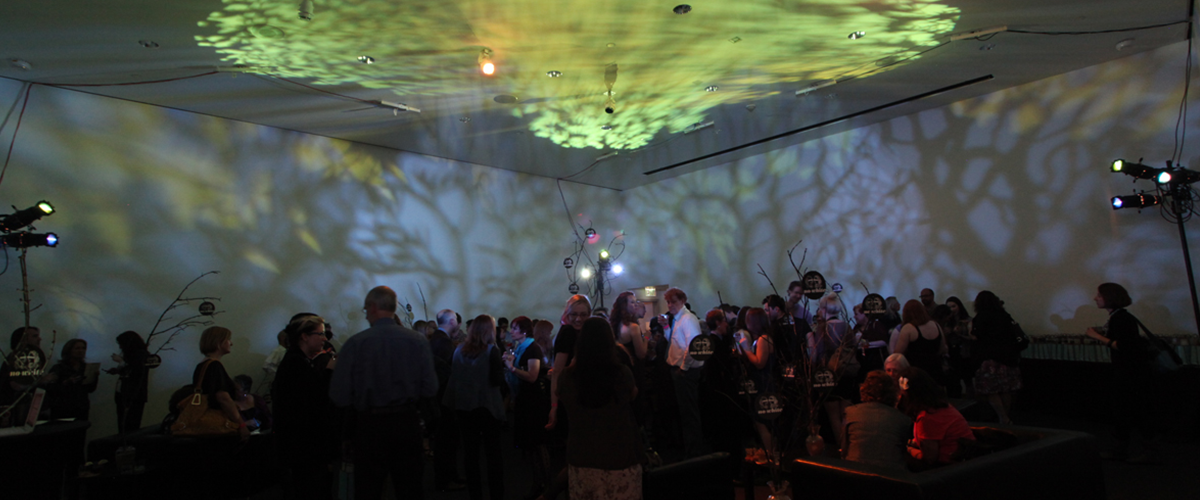people dancing under light show inside WAM