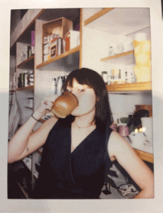 A person drinking from a mug