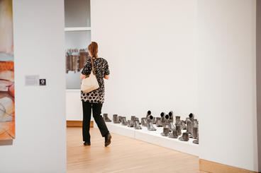 person walking through art exhibit