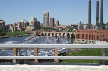 stone arch bridge with Minneapolis in the background